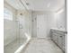 Modern bathroom with glass enclosed shower, tile flooring, and ample natural light at 6012 Millbridge Pkwy, Waxhaw, NC 28173