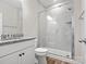 Modern bathroom with sleek white tiles, glass-enclosed shower, and granite countertop vanity at 6012 Millbridge Pkwy, Waxhaw, NC 28173