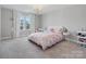 Charming bedroom with a floral bedspread, chandelier, and ample natural light at 6012 Millbridge Pkwy, Waxhaw, NC 28173