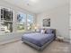 Comfortable bedroom with natural light, plush carpet, and a calming color scheme at 6012 Millbridge Pkwy, Waxhaw, NC 28173