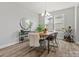 Bright dining room with modern chandelier, stylish furnishings, and ample natural light at 6012 Millbridge Pkwy, Waxhaw, NC 28173