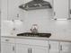 Close up of stovetop and hood in kitchen with white subway tile back splash at 6012 Millbridge Pkwy, Waxhaw, NC 28173
