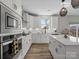 Bright kitchen boasts an island with bar stools, stainless appliances, and natural lighting at 6012 Millbridge Pkwy, Waxhaw, NC 28173