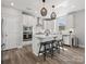 Bright kitchen features an island with stool seating and stainless steel appliances at 6012 Millbridge Pkwy, Waxhaw, NC 28173