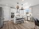 Bright kitchen features an island with stool seating and stainless steel appliances at 6012 Millbridge Pkwy, Waxhaw, NC 28173