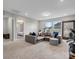 Inviting living room with a plush sectional sofa, neutral carpet, and bright windows at 6012 Millbridge Pkwy, Waxhaw, NC 28173
