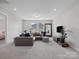 Comfortable living room area with a plush sectional sofa and soft carpet at 6012 Millbridge Pkwy, Waxhaw, NC 28173