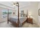 Spacious bedroom featuring a four-poster bed, tray ceiling, and natural light from the window at 6315 Prosperity Church Rd, Charlotte, NC 28269