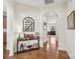 Charming entryway features hardwood floors, elegant console table with decor and an arched doorway at 6315 Prosperity Church Rd, Charlotte, NC 28269