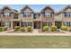 Charming townhome with brick facade, black shutters, manicured landscaping, and a welcoming entrance at 6315 Prosperity Church Rd, Charlotte, NC 28269