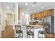 Kitchen with granite counters, stainless appliances, breakfast bar and arched doorway leading to living spaces at 6315 Prosperity Church Rd, Charlotte, NC 28269