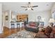 Inviting living room features hardwood floors, a ceiling fan, and a cozy seating area with a comfortable couch at 6315 Prosperity Church Rd, Charlotte, NC 28269