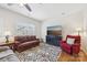 Cozy living room with plush seating, hardwood floors, and a large window providing ample natural light at 6315 Prosperity Church Rd, Charlotte, NC 28269
