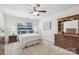 Bright main bedroom with a plush bed, ceiling fan, and a window for natural light at 6315 Prosperity Church Rd, Charlotte, NC 28269