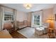 Charming Bedroom featuring a brass crib, soft colors, and natural light at 6624 Lancer Dr, Charlotte, NC 28226