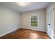 This bedroom features hardwood floors and a large window offering natural light at 6624 Lancer Dr, Charlotte, NC 28226