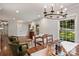 Charming dining area with hardwood floors, large windows, and a rustic-chic chandelier at 6624 Lancer Dr, Charlotte, NC 28226
