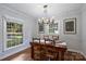 Elegant dining space featuring hardwood floors, contemporary lighting, and ample natural light at 6624 Lancer Dr, Charlotte, NC 28226