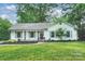 Charming single story home featuring a well maintained lawn, flower beds, and traditional design at 6624 Lancer Dr, Charlotte, NC 28226