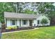 Well-manicured lawn leads to a lovely home, highlighting its inviting facade and landscaping at 6624 Lancer Dr, Charlotte, NC 28226