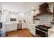 Well-lit kitchen with white cabinetry, stainless steel appliances, and stylish wooden accents at 6624 Lancer Dr, Charlotte, NC 28226