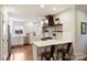 Modern kitchen with stainless steel appliances, white cabinetry, and a breakfast bar at 6624 Lancer Dr, Charlotte, NC 28226