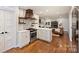 Stylish kitchen with open layout featuring hardwood floors, quartz counters, and modern fixtures at 6624 Lancer Dr, Charlotte, NC 28226