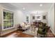 Spacious living area showcasing hardwood floors, natural light, and a seamless flow to dining at 6624 Lancer Dr, Charlotte, NC 28226