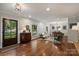 Bright living room with hardwood floors, stylish decor, and an open flow to the dining area at 6624 Lancer Dr, Charlotte, NC 28226