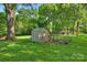 Wonderful backyard with chicken coop, shed, and mature trees, all on a lush lawn at 6624 Lancer Dr, Charlotte, NC 28226