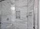 Shower with sleek, modern tiling and fixtures, featuring a convenient built-in shelf at 6624 Lancer Dr, Charlotte, NC 28226