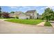 Spacious backyard with lush green grass and a detached garage at 6948 Church Wood Ln, Huntersville, NC 28078