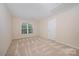 Bedroom features natural light from window, light walls, and carpet flooring at 6948 Church Wood Ln, Huntersville, NC 28078