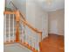 Bright entryway featuring hardwood floors, a staircase with wood railing, and neutral wall colors at 6948 Church Wood Ln, Huntersville, NC 28078