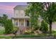 Charming two-story home with manicured landscaping, inviting front porch, and classic architectural details at 6948 Church Wood Ln, Huntersville, NC 28078