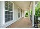 Spacious front porch with classic columns and iron railing, offering a welcoming entrance to the home at 6948 Church Wood Ln, Huntersville, NC 28078