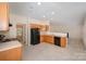 Well-equipped kitchen with tile flooring, ample cabinet space, and an open view to the living room at 6948 Church Wood Ln, Huntersville, NC 28078