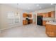 Bright kitchen featuring wooden cabinets, a black refrigerator, black stove and tile flooring at 6948 Church Wood Ln, Huntersville, NC 28078