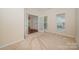 Office with double French doors, neutral carpet and a window overlooking the backyard at 6948 Church Wood Ln, Huntersville, NC 28078