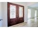 Elegant foyer with decorative glass double doors and light, modern flooring at 7416 Quail Ridge Dr, Charlotte, NC 28226