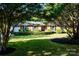Well-maintained front lawn showcasing a brick home with lush, trimmed hedges at 7416 Quail Ridge Dr, Charlotte, NC 28226