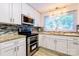 Modern kitchen featuring stainless steel appliances, granite countertops, and tile backsplash at 7416 Quail Ridge Dr, Charlotte, NC 28226