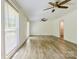 Spacious living room with hardwood floors, ceiling fan, and lots of natural light at 7416 Quail Ridge Dr, Charlotte, NC 28226