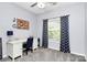 Bright bedroom with a light gray walls, desk, patterned curtains, and natural light at 7544 Rolling Meadows Ln, Huntersville, NC 28078