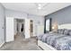 Light and bright bedroom featuring plush carpeting, a ceiling fan, and two large windows at 7544 Rolling Meadows Ln, Huntersville, NC 28078