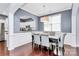 Cozy dining room featuring hardwood floors, modern decor, and seamless kitchen access at 7544 Rolling Meadows Ln, Huntersville, NC 28078