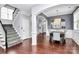 Inviting dining room featuring hardwood floors, stylish lighting, and staircase access at 7544 Rolling Meadows Ln, Huntersville, NC 28078