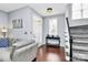 Welcoming entryway featuring hardwood floors, a staircase, and a view of the bright living area at 7544 Rolling Meadows Ln, Huntersville, NC 28078