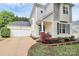 Charming two-story home with a detached garage and manicured landscaping at 7544 Rolling Meadows Ln, Huntersville, NC 28078