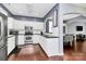 Eat-in kitchen with stainless steel appliances, white cabinets, and access to the dining room at 7544 Rolling Meadows Ln, Huntersville, NC 28078